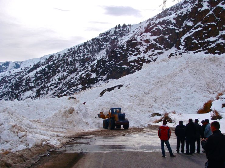 We passed a large artillery piece just wrapping up some control work along the road, and an hour later encountered its leavings.  This wet-slab buried the road in a 300-foot long block of cement fifty feet high.  We carried our bikes and bags over it in an hour's effort, smirking at the hundreds of cars lined up for 14 hours.  Bikes win.