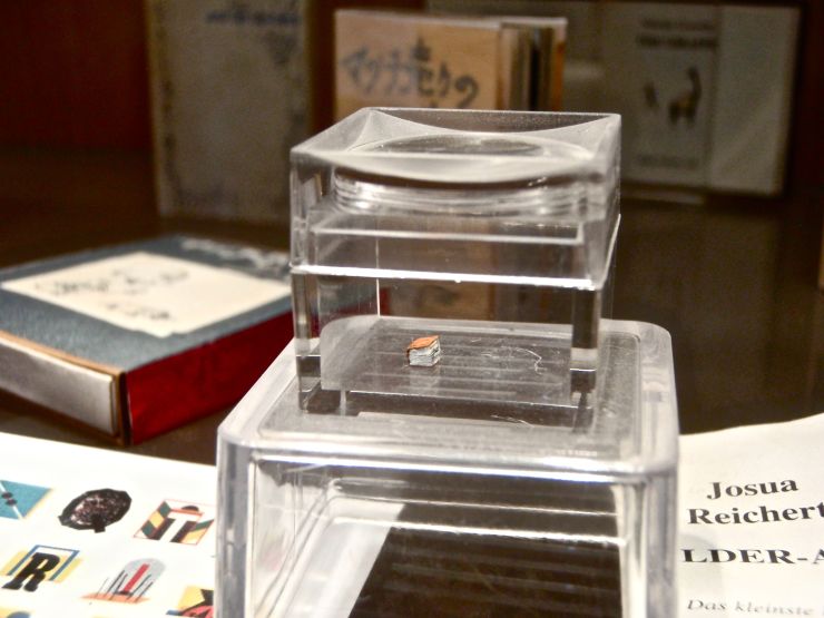 To see the supposed smallest book in the world, pay the Museum of Miniature Books a visit.  You won't be sorry.  Admission is free.